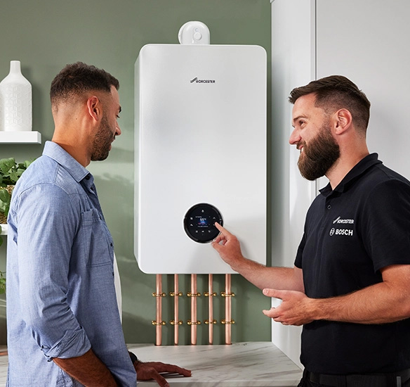 Miller Freeman engineers beside a Worcester boiler